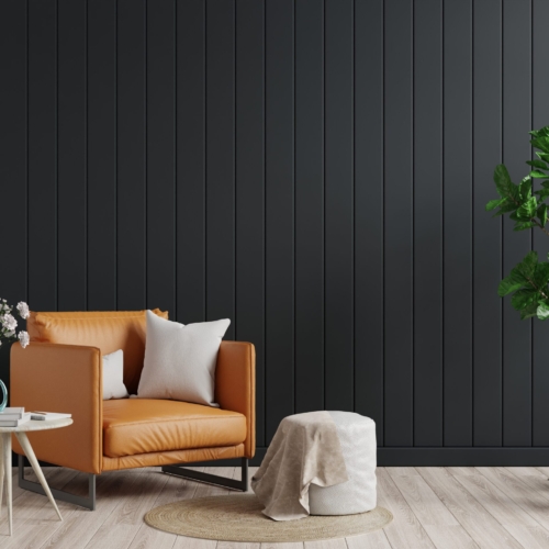 Living room interior wall mockup in dark tones with leather armchair on black wooden wall background.3d rendering